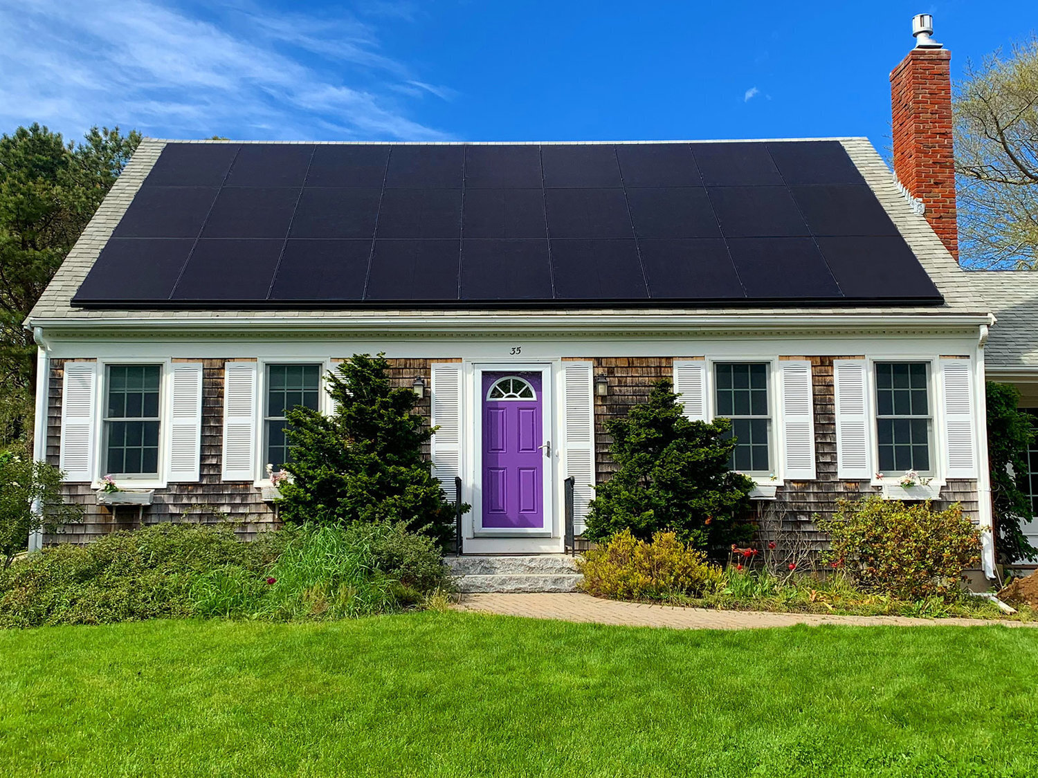 Home with an all-black rooftop solar panel installation